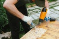 Man removing old varnish from wood using scraper and heat gun. Royalty Free Stock Photo