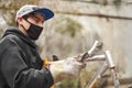 Man removing the paint of an orange bicycle frame during a bike renovation work Royalty Free Stock Photo