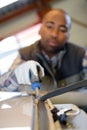 Man removing rubber windscreen beading