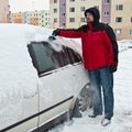 Man removing snow from car