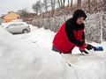 Man removing snow from car