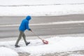 Man Removing Snow in His Driveway with a Shovel 4