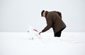 Man removing snow with a shovel