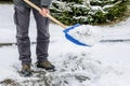 Man removing snow from the sidewalk after snowstorm Royalty Free Stock Photo
