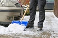 Man removing snow from the sidewalk after snowstorm Royalty Free Stock Photo