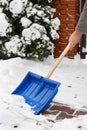 Man removing snow from the sidewalk after snowstorm Royalty Free Stock Photo