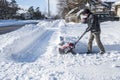 Man Removing Snow with a Snowblower on a Sunny Day 3