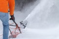 a man removing snow with a special blow machine Royalty Free Stock Photo