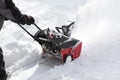 Man removing snow after storm with a snowblower