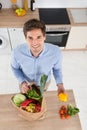 Man Removing Vegetables From Grocery Bag Royalty Free Stock Photo