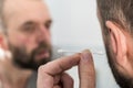 Man removing wax from ear using Q-tip Royalty Free Stock Photo