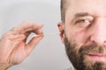 Man removing wax from ear using Q-tip Royalty Free Stock Photo