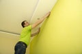 Man renovates room interior with a plastic molding Royalty Free Stock Photo