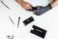 Man repair disassembled broken smartphone flat lay