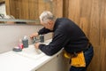 Man repair and fixing leaky faucet in bathroom.