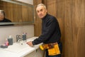 Man repair and fixing leaky faucet in bathroom. Royalty Free Stock Photo
