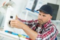 Man repairer working in workshop and repairing device