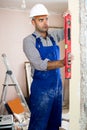 Man repairer working with spirit level