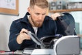 Man repairing broken domestic printer