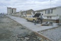 Man repairing car in poor neighborhood,