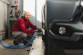 Man repairing a car wheel in a garage Royalty Free Stock Photo