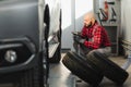 Man repairing a car wheel in a garage Royalty Free Stock Photo