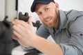 man repairing chair by hand with removable castors Royalty Free Stock Photo