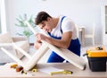 Man repairing chair in the room Royalty Free Stock Photo