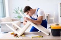 The man repairing chair in the room Royalty Free Stock Photo