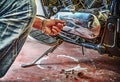 Man repairing a classic motorcycle