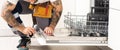 man repairing dishwasher. Male hand with screwdriver installs kitchen appliances, close up Royalty Free Stock Photo