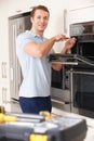 Man Repairing Domestic Oven In Kitchen Royalty Free Stock Photo