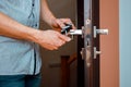 a man repairing a doorknob