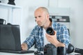 man repairing dslr lense looking up on internet for help