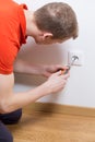 Man repairing electrical socket