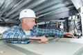 Man repairing electrical wiring on ceiling