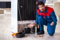 The man repairing fridge with customer Royalty Free Stock Photo