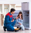 Man repairing fridge with customer Royalty Free Stock Photo