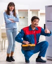 Man repairing fridge with customer Royalty Free Stock Photo