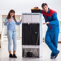 Man repairing fridge with customer Royalty Free Stock Photo