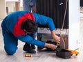 Man repairing fridge with customer Royalty Free Stock Photo