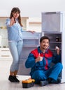 Man repairing fridge with customer Royalty Free Stock Photo