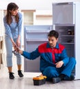 Man repairing fridge with customer Royalty Free Stock Photo