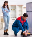 Man repairing fridge with customer Royalty Free Stock Photo