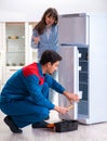 Man repairing fridge with customer Royalty Free Stock Photo