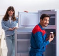 Man repairing fridge with customer Royalty Free Stock Photo