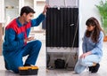 Man repairing fridge with customer Royalty Free Stock Photo