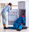 Man repairing fridge with customer Royalty Free Stock Photo