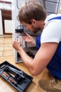 Man repairing fridge at home Royalty Free Stock Photo