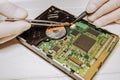 Man repairing hard disk. Inside details of the old personal computer. Broken PC.  Screwdriver and pincers in hands Royalty Free Stock Photo